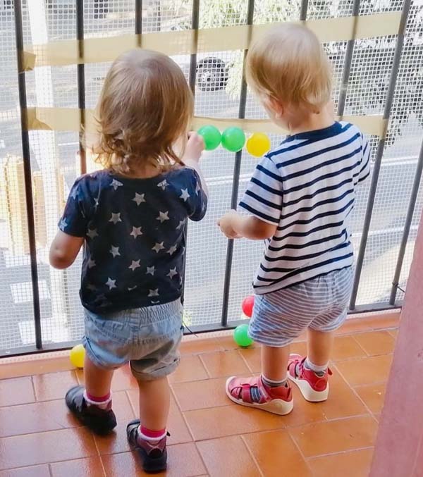 Alex and Maya looking out on a balcony