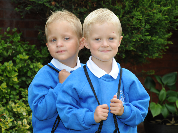 Twin boys look at the camera